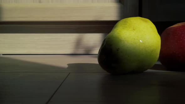 An apple and a pear in the sunset, with dolly movement