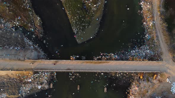 Vietnamese throwing garbage in local river. Landscape filled with trash. Aerial top down view