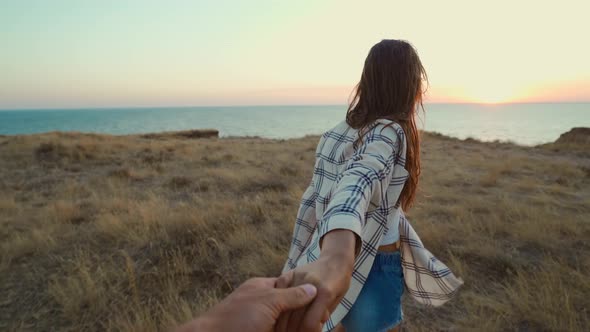 Happy Positive Emotions Girl Laughing and Holding Hand of Her Friend on Cliff with Seascape During