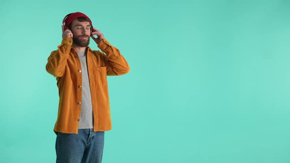 Cheerful Guy Listening to Music in Headphones