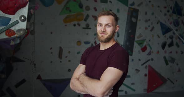 Medium Shot Portrait of a Young Bearded Smiling Climber with Crossed Arms