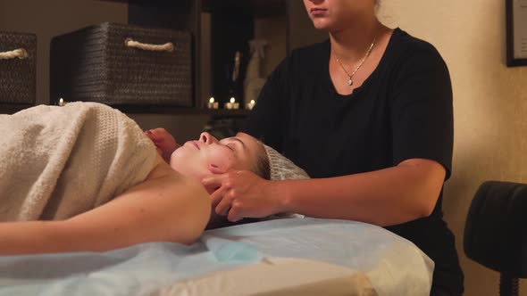 The Masseur Does an Antistress Massage of the Neck with His Hands with Oil