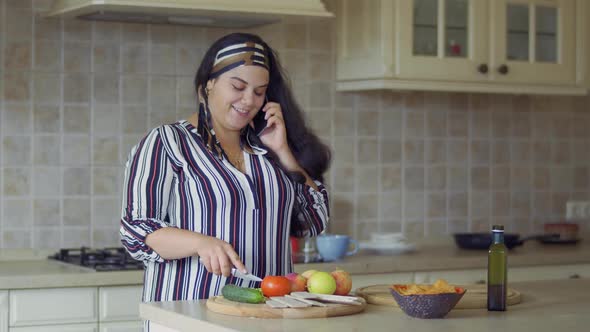 Plump Girl Is Cooking in the Kitchen