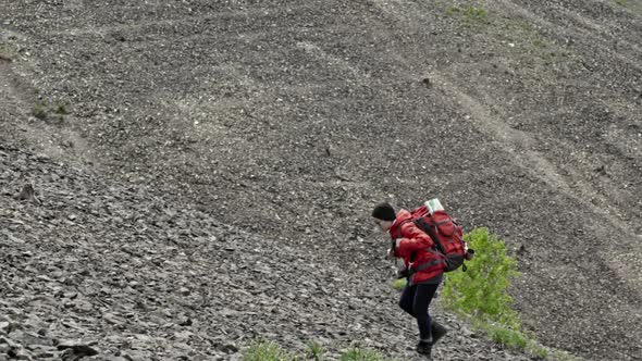 Woman Hiker Walking up Slope