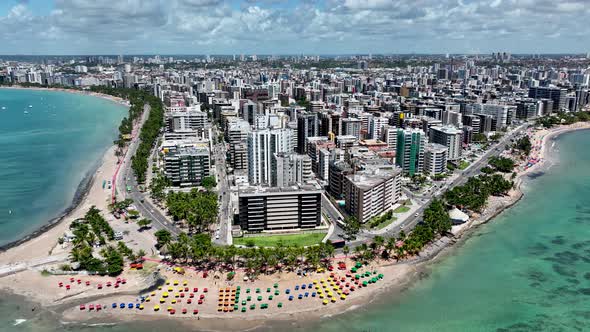 Aerial panning shot of turquoise water beach at Maceio Alagoas Brazil.