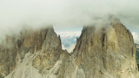 fly high through clouds at Langkofel mountain peak, Dolomites Italy