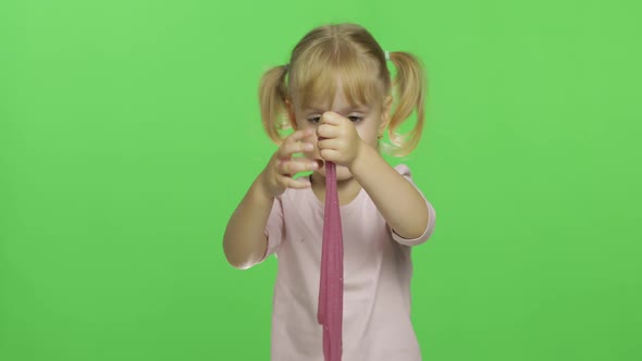 Kid Playing with Hand Made Toy Slime. Child Having Fun Making Pink Slime