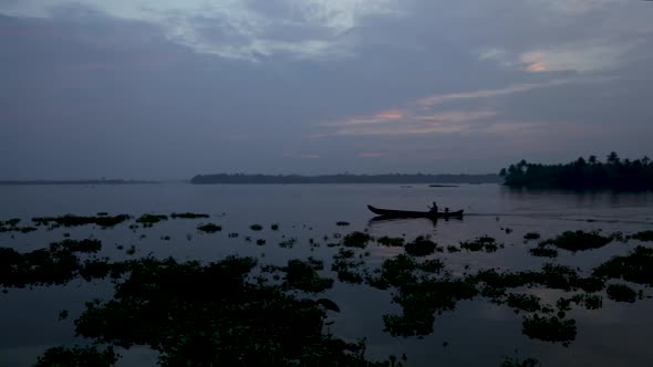 Silhouette of boat and fisherman in backwaters crossing , Steady Shot