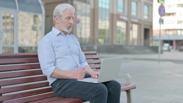 Old Man Talking on Video Call While Sitting Outdoor on Bench
