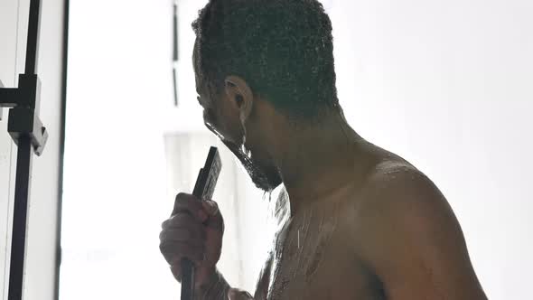 Joyful AfricanAmerican Man Sings Taking Hot Shower at Home