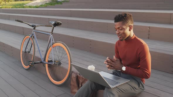 African American Man Video Chatting on Laptop Outdoors