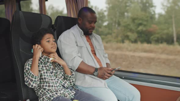 African American Man with Son on Bus Ride