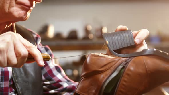 Shoemaker repairing a shoe