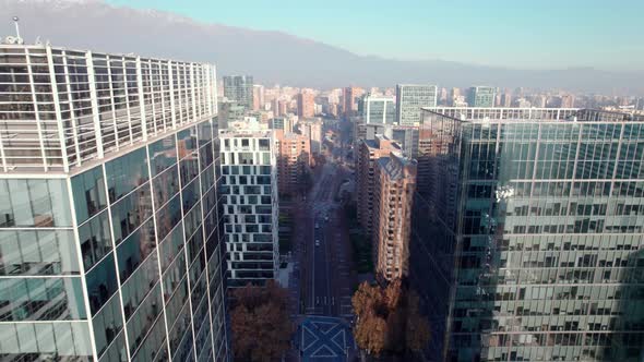 Aerial view dolly in of buildings in Las Condes, Santiago, Chile. Mountains in the background