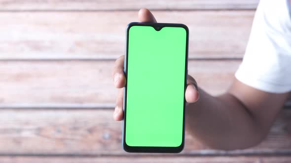 Close Up of Young Man Hand Using Smart Phone with Green Screen