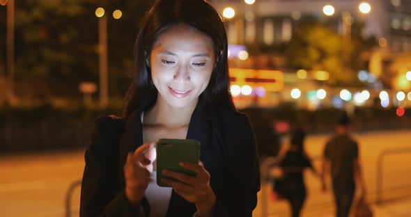 Business woman use of smart phone at night 