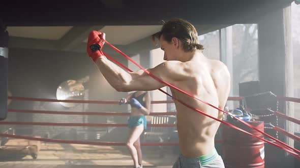 Confident Young Man Training in the Boxing Club