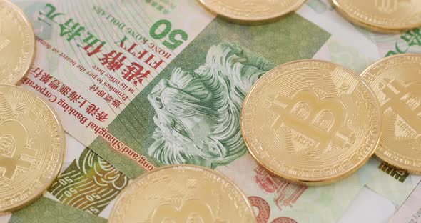 Bitcoin and Hong Kong banknote in spinning