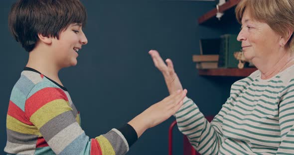 Grandmother and Teenage Grandson are Playing a Game Together