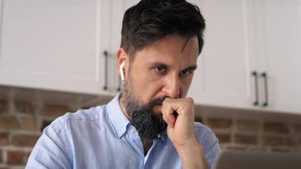 Close up video of concentrated man working at home. Shot with RED helium camera in 8K.