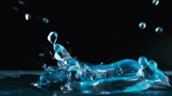 Many Drops of Water Fall on the Surface of the Water in Slow Motion Macro Shot