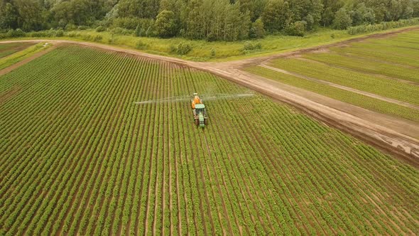 Tractor is Spraying Fertilizers Field