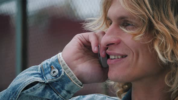 Portrait of smiling man speaking on mobile phone