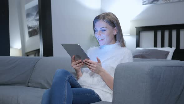 Amazed Woman Using Tablet at Home, Wondering