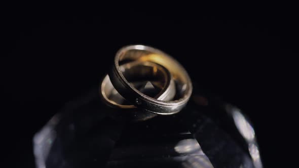 Wedding Rings Lying on Crystal Shining with Light Close Up Macro