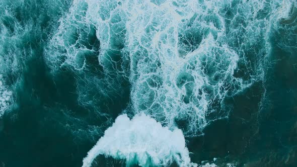 Huge Ocean Wave Rolls on Deep Green Water Upper View