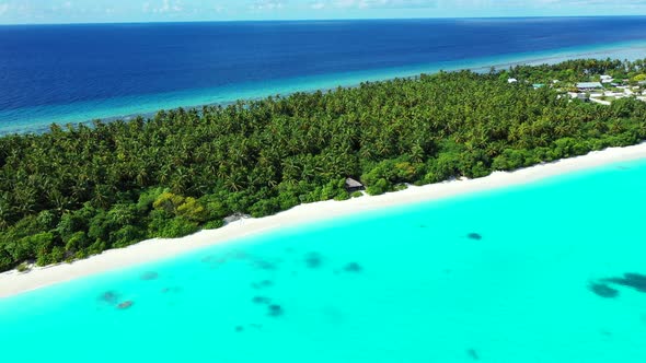Tropical fly over tourism shot of a sunshine white sandy paradise beach and aqua turquoise water bac
