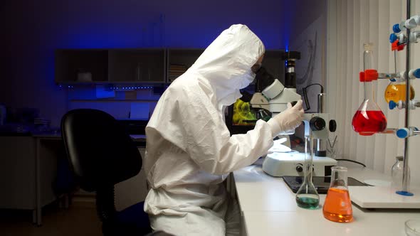 Scientist Examining Samples with Microscope