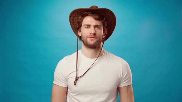 Attractive Shocked Young Man in Cowboy Hat Extremely Happy with Wide Open Mouth