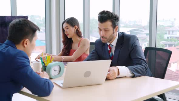 Smart Businessman and Businesswoman Talking Discussion in Group Meeting