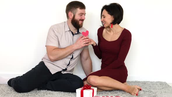 Husband and wife giving Valentines gifts.