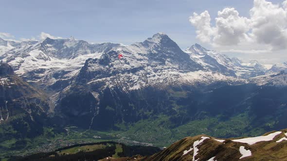 Paragliding over the Grindelwald valley in Switzerland (aerial view)