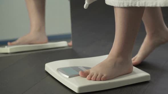 Healthy Dieting, Woman Stepping on Scales to See Result, Normal Weight Range