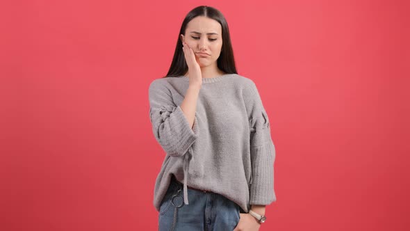 Young Woman Isolated on Red Background Suffering From Severe Toothache.