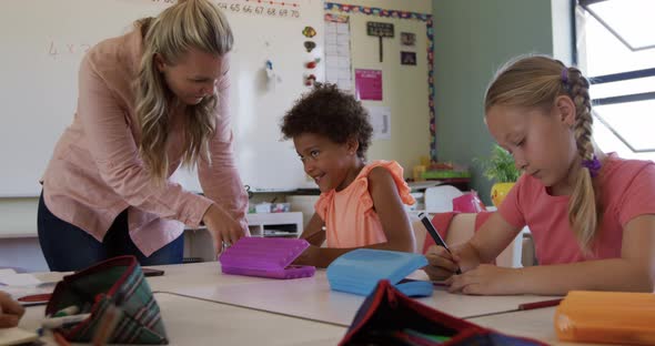 Female teacher teaching kids in the class