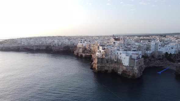 Waterfront Buildings On Cliffs In Polignano a Mare In Puglia, Italy With View Of Cliff Diving Ramp A