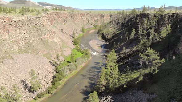 Broken Crumbled Rocks Spilling From the Narrow Canyon Slope Ridge Towards the Deep Valley Floor