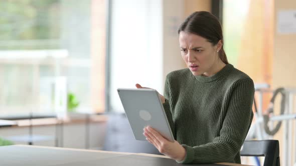 Young Woman Reacting To Loss on Tablet