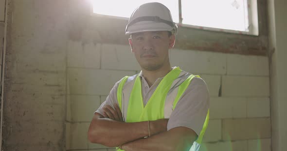 Industrial Engineer Man In Hard Hat Wearing Safety Jacket Working In The Building Construction Site.