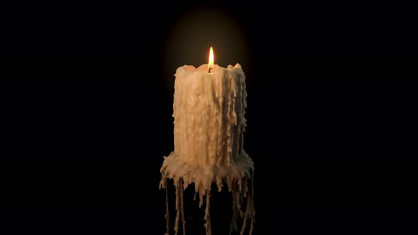 An old and melted candle rotates in front of a black background