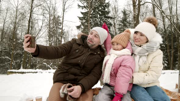 Man Taking Selfie with Family