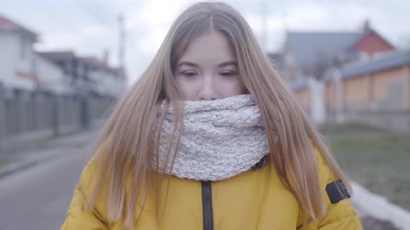 Portrait of Cute Caucasian Girl in Yellow Coat and White Scarf Standing Outdoors, Pretty Teen