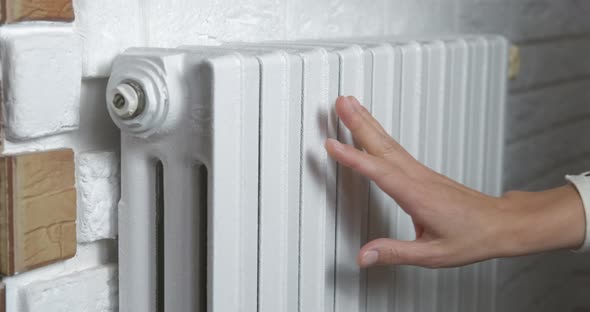 Hands From a Heating Radiator