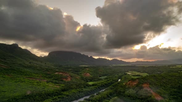 Beautiful sunset of clouds boiling across a golden sky, Kauai, Hawaii, Menehune Fishpond, aerial hyp