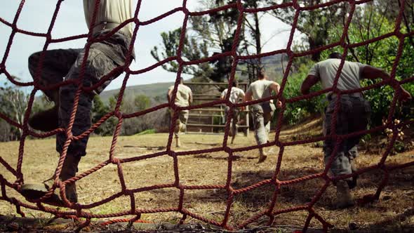 Military troops running during obstacle course 4k