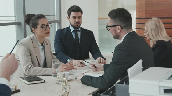 Attorneys Having Heated Discussion at Meeting Table